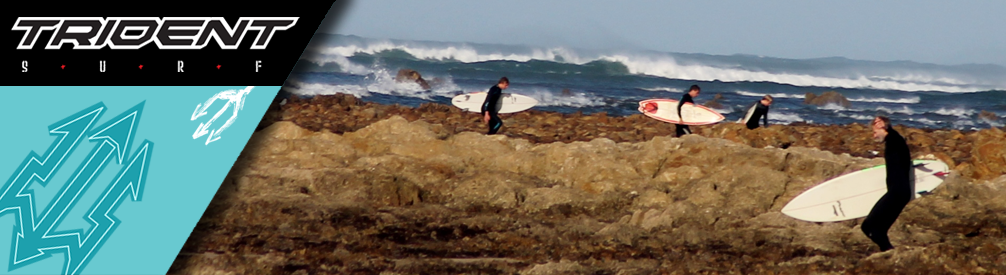 Surfers in sharp rocks.